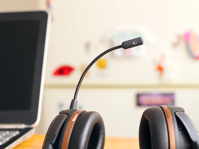 Support headset resting next to a laptop on a desk
