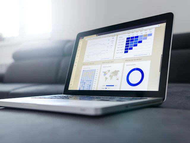 Laptop displaying business reports and charts