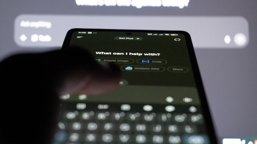 Person typing a question to an AI chatbot on a smartphone