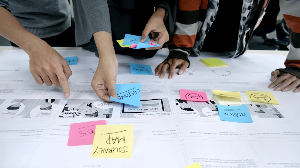 Team planning a project with colorful sticky notes on a table