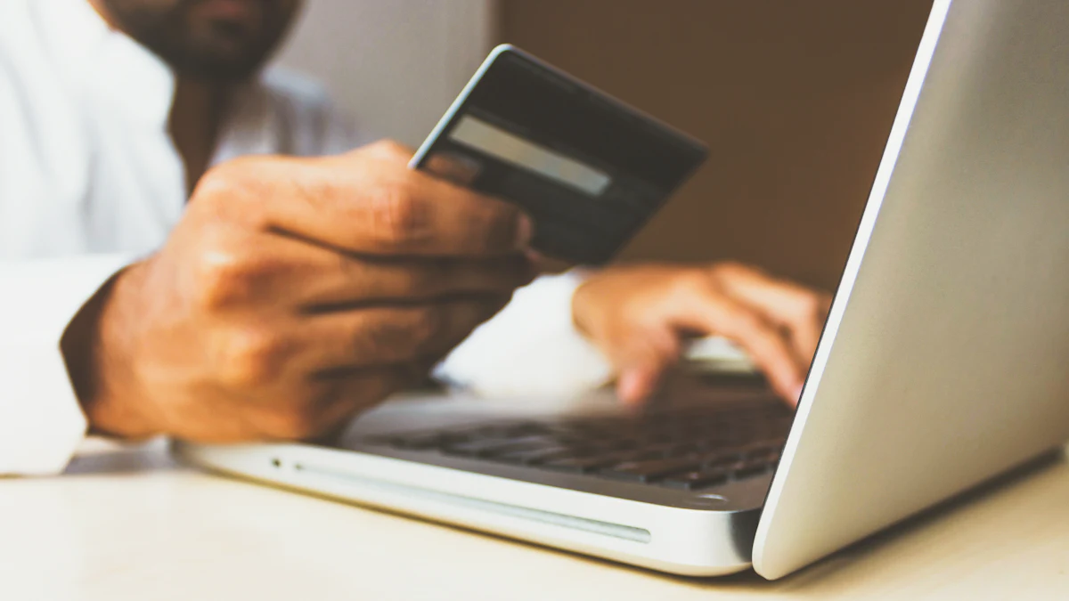 Person shopping online on a laptop with a payment card