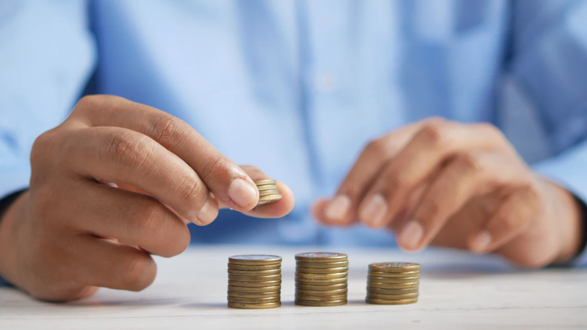 Hand stacking coins on a table, a symbol of budgeting